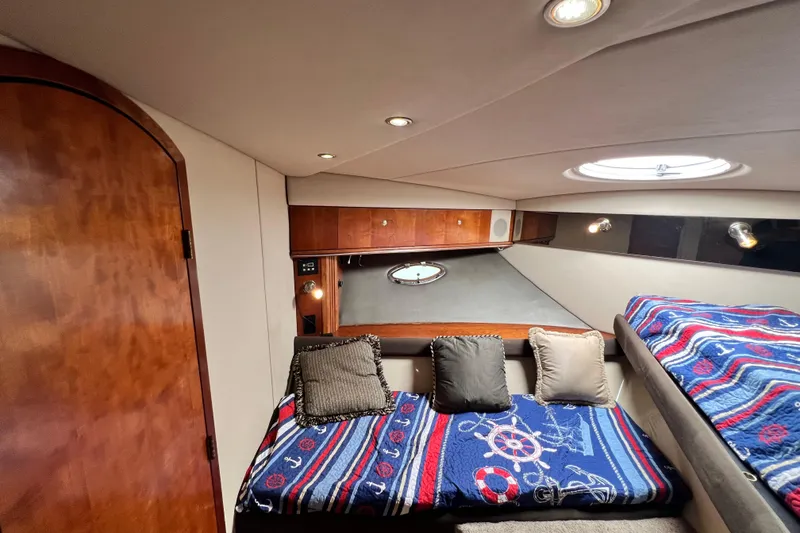 Slide: The Image of Luxurious cabin interior of 2005 Cruisers Yachts 440 Express with nautical-themed bedding. - 79
