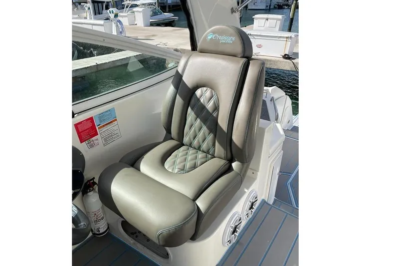 Slide: The Image of Captain's seat on 2005 Cruisers Yachts 440 Express, featuring quilted upholstery and sleek design. - 8
