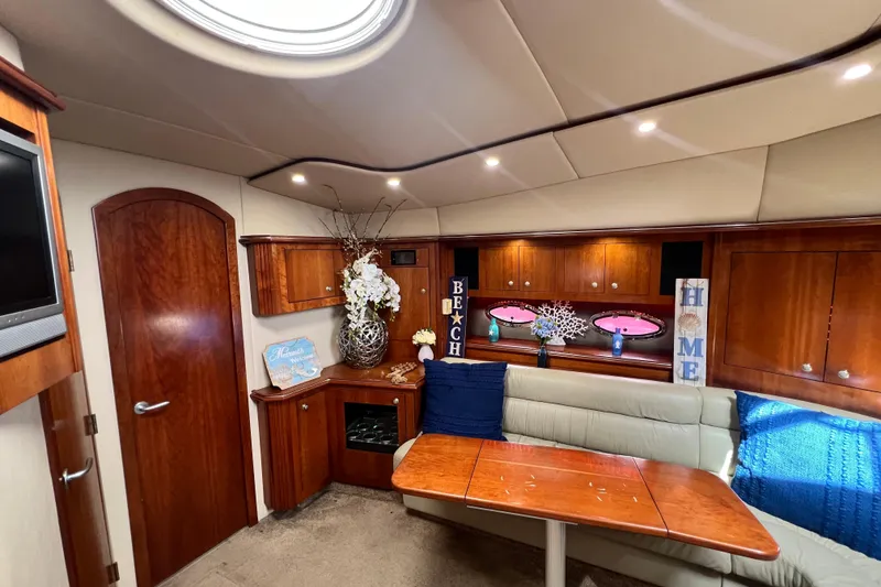 Slide: The Image of Luxurious interior of 2005 Cruisers Yachts 440 Express with elegant wood finishes and cozy seating. - 80