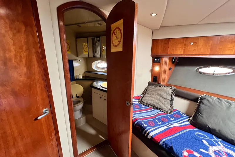 Slide: The Image of 2005 Cruisers Yachts 440 Express interior with cozy cabin and bathroom. - 83