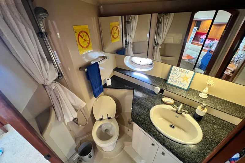 Slide: The Image of Bathroom interior of 2005 Cruisers Yachts 440 Express with sink, toilet, and decor. - 84