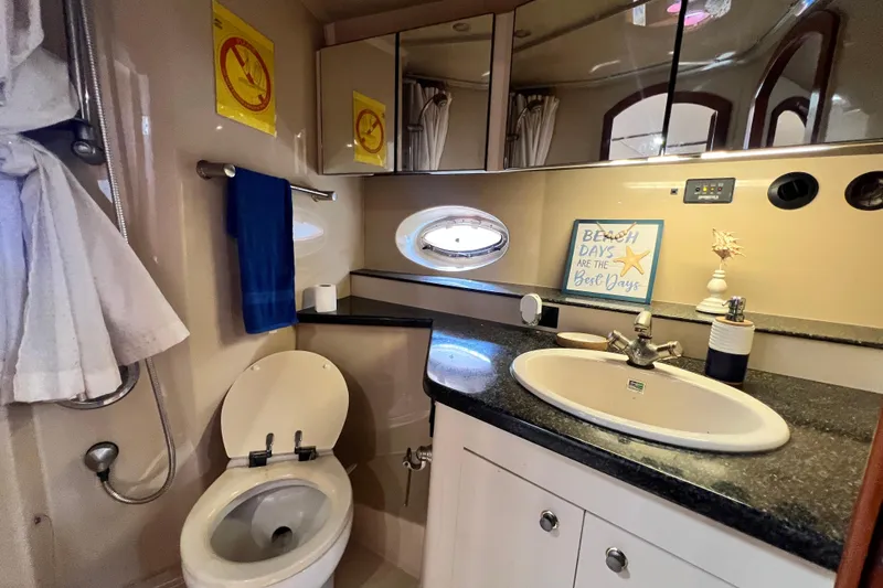 Slide: The Image of Bathroom interior of 2005 Cruisers Yachts 440 Express with sink, toilet, and decor. - 85