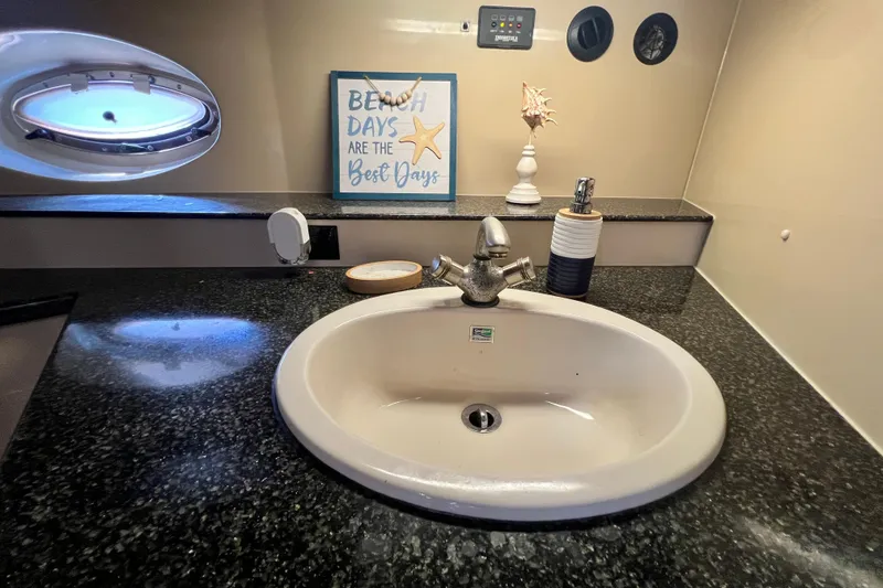 Slide: The Image of Bathroom sink area in 2005 Cruisers Yachts 440 Express with nautical decor. - 86