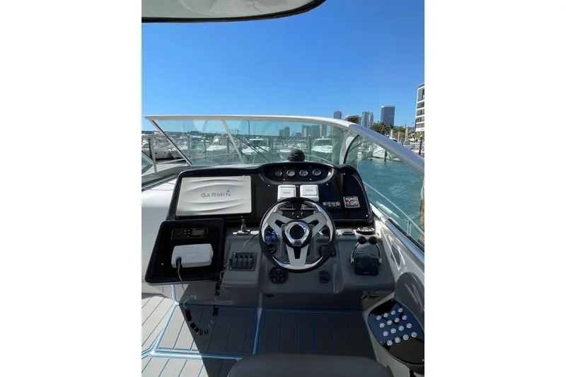 Slide: The Image of Helm of 2005 Cruisers Yachts 440 Express with Garmin navigation, docked in a marina. - 9