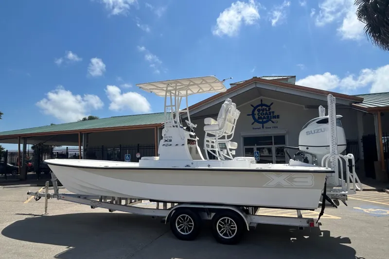The Image of 2026 Shallow Sport 25 X3 boat on trailer outside Gulf Coast Marine dealership. - 21