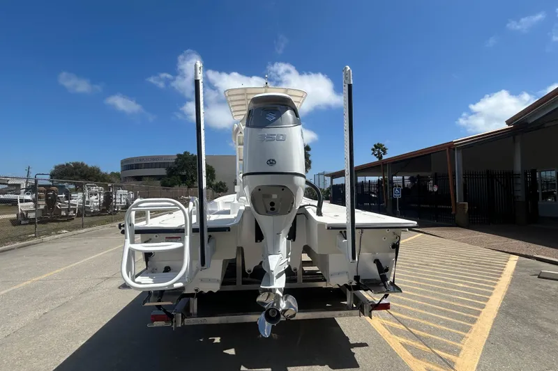 Slide: The Image of 2026 Shallow Sport 25 X3 boat with powerful outboard motor, parked outdoors. - 25