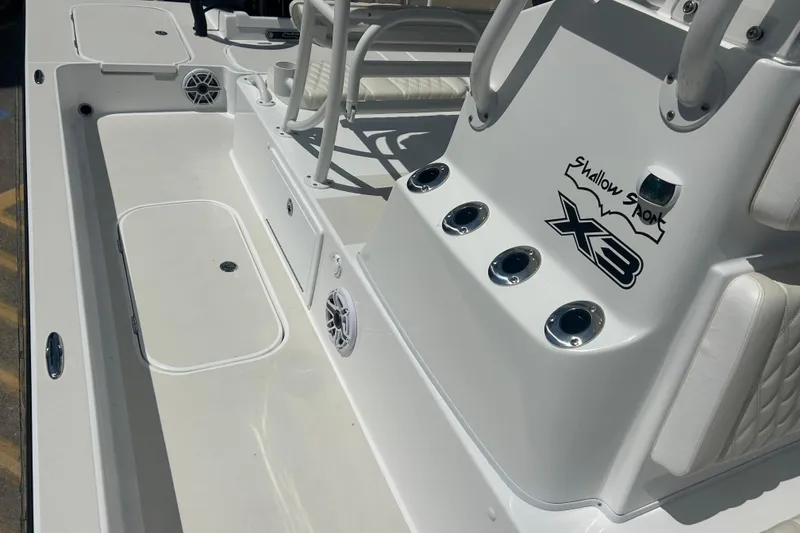 Slide: The Image of 2026 Shallow Sport 25 X3 boat interior with seating and rod holders. - 30