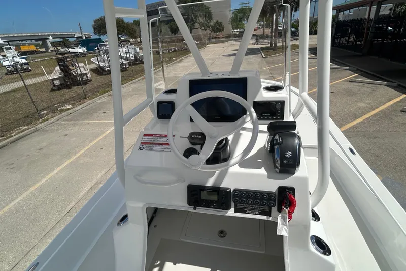 Slide: The Image of 2026 Shallow Sport 25 X3 boat console with steering wheel and controls. - 33