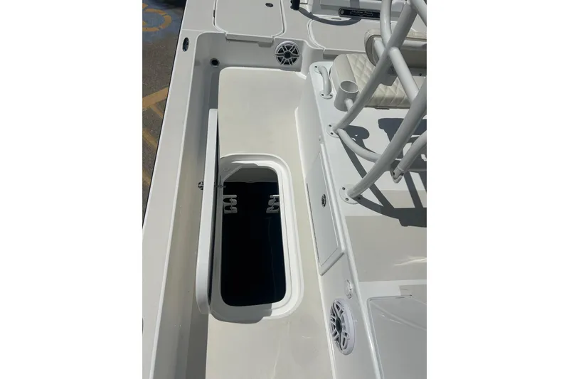 Slide: The Image of 2026 Shallow Sport 25 X3 boat interior with open storage compartment and seating. - 34