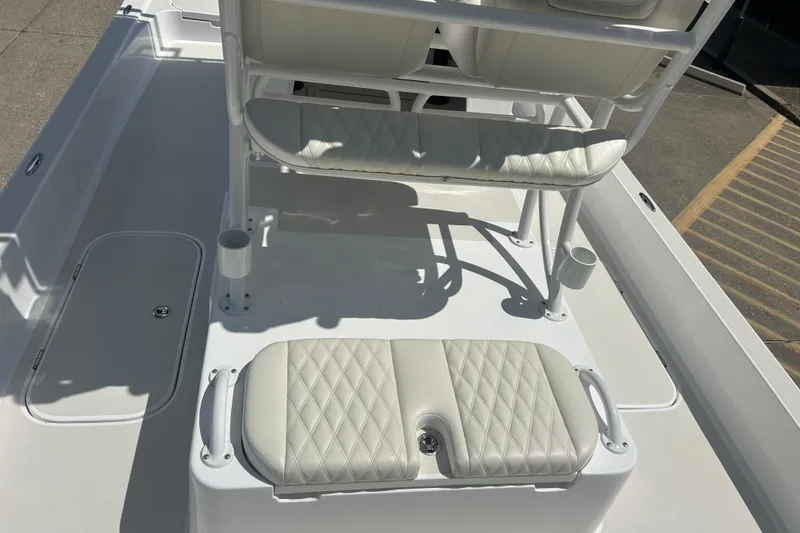 Slide: The Image of 2026 Shallow Sport 25 X3 boat interior with white cushioned seating and rod holders. - 35