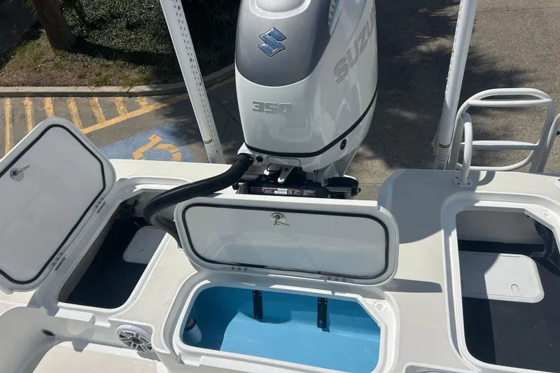 Slide: The Image of 2026 Shallow Sport 25 X3 boat with Suzuki 350 engine and open storage compartments. - 39