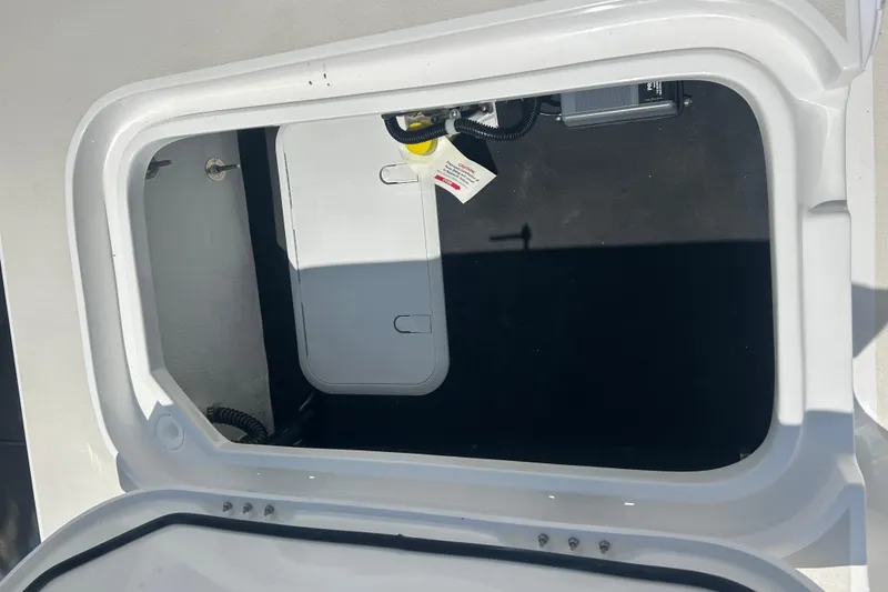 Slide: The Image of Open storage compartment of 2026 Shallow Sport 25 X3 boat, showcasing interior details. - 41