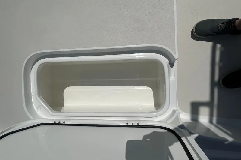 Slide: The Image of Open storage compartment on 2026 Shallow Sport 25 X3 boat deck. - 43