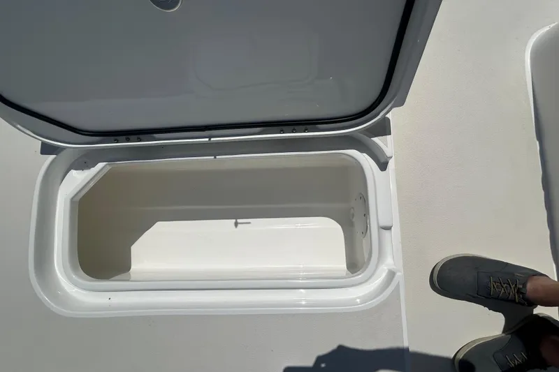 Slide: The Image of Open storage compartment on 2026 Shallow Sport 25 X3 boat deck. - 44