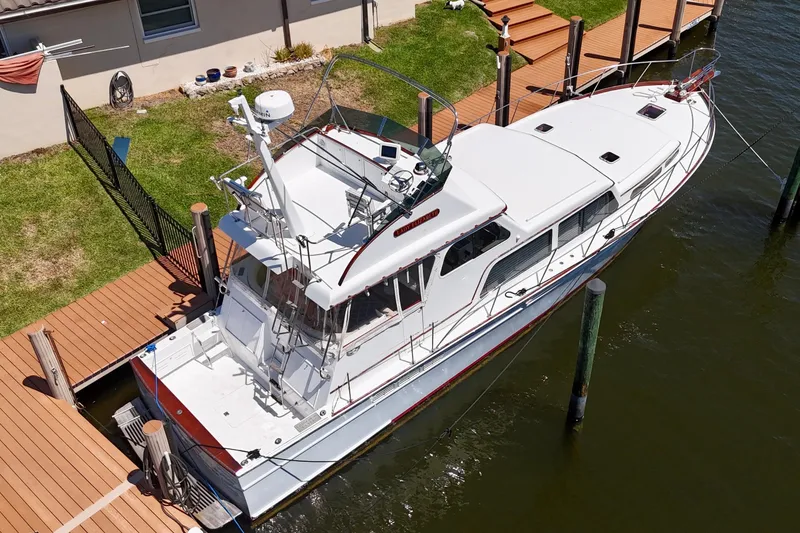 Slide: The Image of Huckins Atlantic 44 yacht, 2006 model, docked at a wooden pier, aerial view. - 15