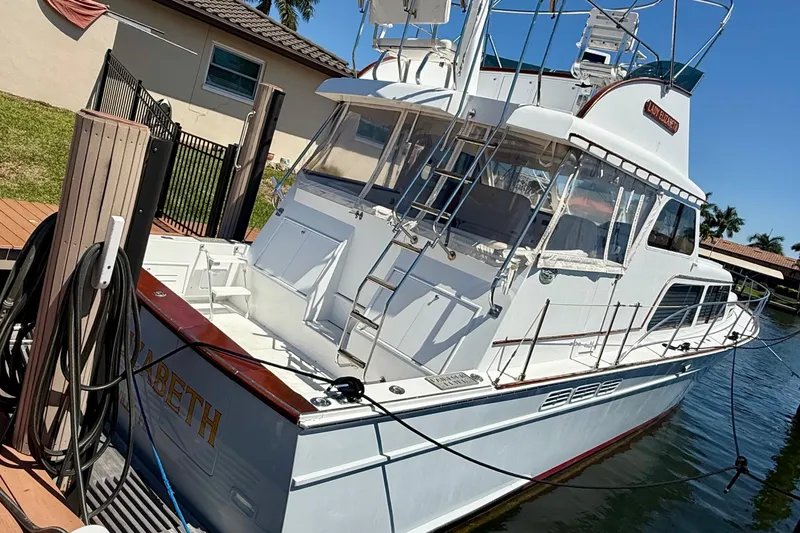 Slide: The Image of 2006 Huckins Atlantic 44 yacht docked, featuring sleek design and spacious deck area. - 16