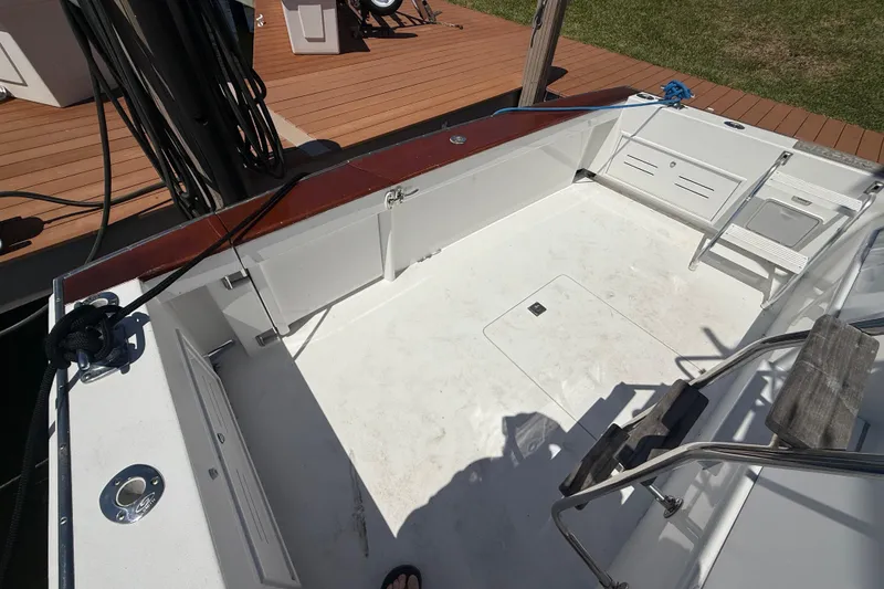 Slide: The Image of Huckins Atlantic 44 boat deck, 2006 model, featuring spacious white interior and wooden accents. - 17