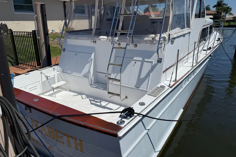 Slide: The Image of Huckins Atlantic 44 yacht, 2006 model, docked with visible ladder and deck area. - 20