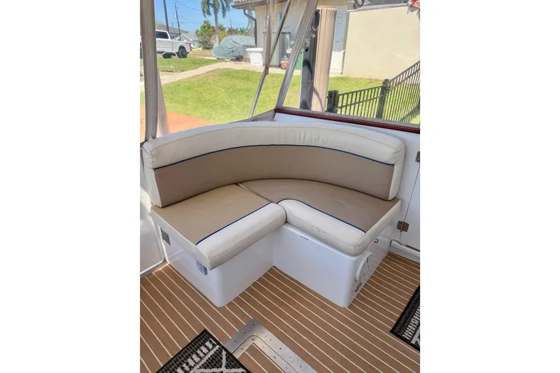 Slide: The Image of Luxury seating on 2006 Huckins Atlantic 44 yacht, featuring cushioned corner bench. - 21