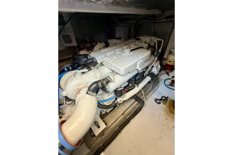 Slide: The Image of Engine room of 2006 Huckins Atlantic 44 yacht, showcasing a clean, well-maintained engine. - 25