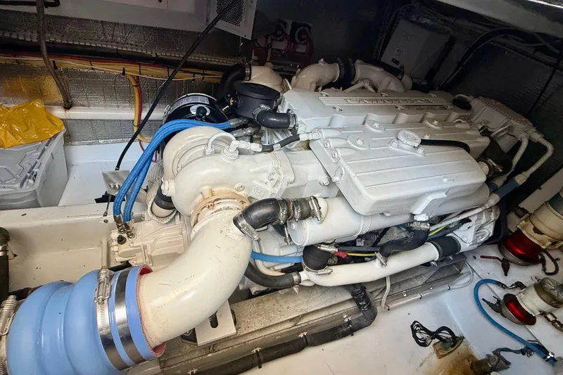 Slide: The Image of Engine compartment of a 2006 Huckins Atlantic 44 yacht, showcasing detailed mechanical components. - 27
