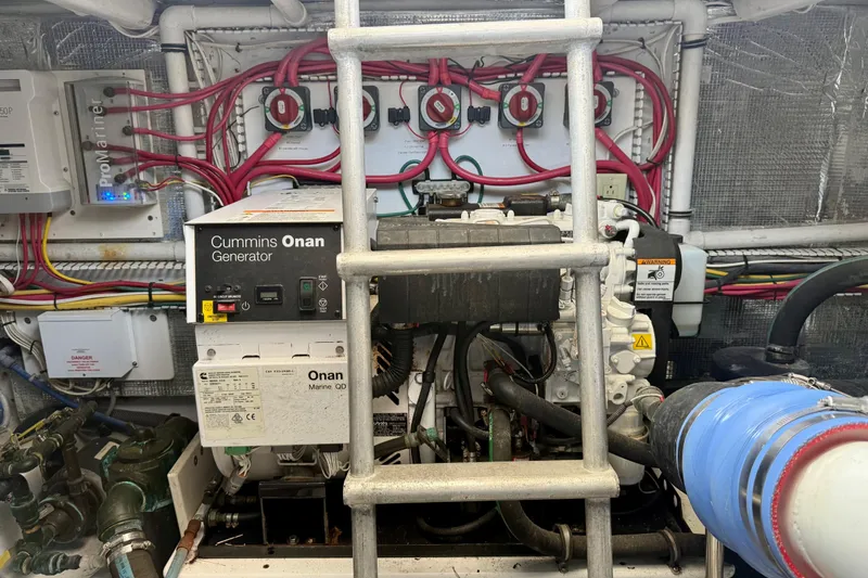 Slide: The Image of Engine room of 2006 Huckins Atlantic 44 with Cummins Onan generator and wiring. - 29