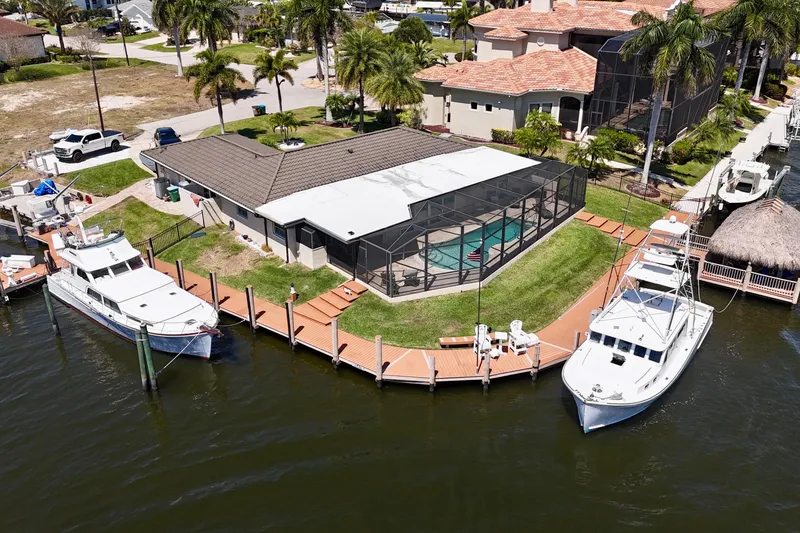 Slide: The Image of Aerial view of a 2006 Huckins Atlantic 44 docked by a waterfront home. - 3