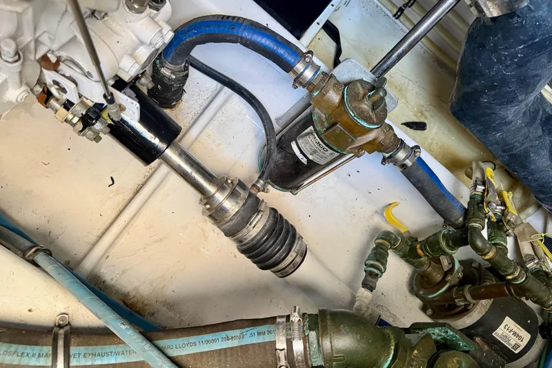 Slide: The Image of Engine room of a 2006 Huckins Atlantic 44, showcasing mechanical components and piping. - 30