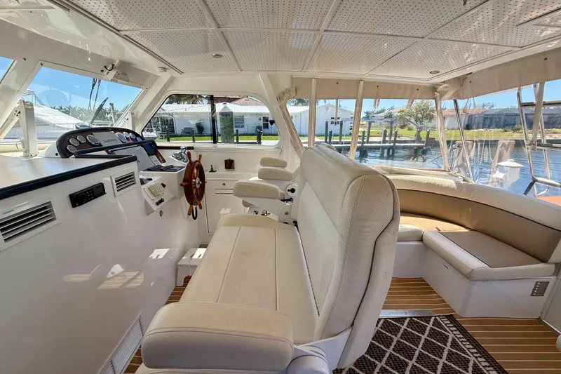 Slide: The Image of Interior of 2006 Huckins Atlantic 44 yacht with helm, seating, and panoramic windows. - 32