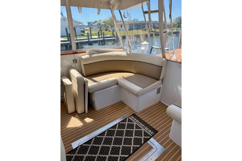 Slide: The Image of Interior of 2006 Huckins Atlantic 44 yacht with cushioned seating and wooden flooring. - 34