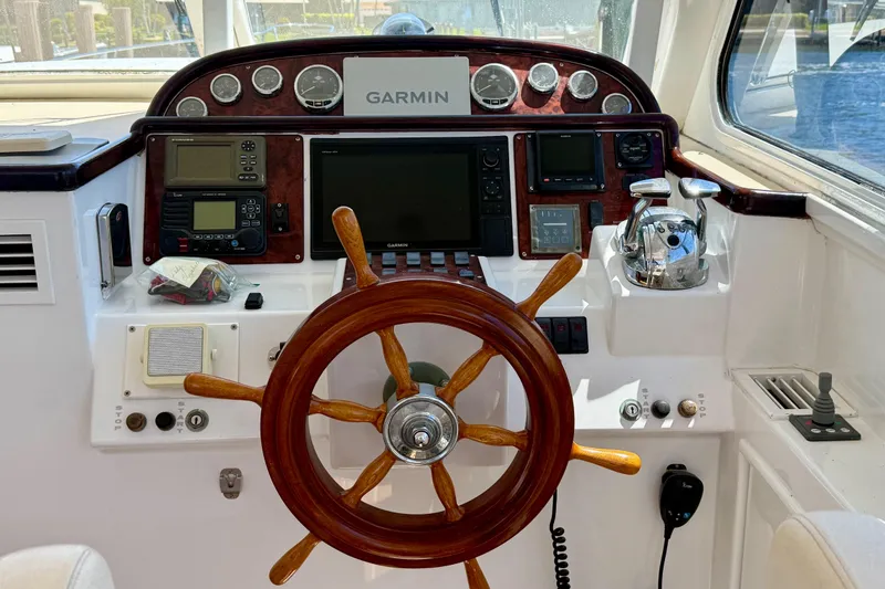 Slide: The Image of Helm of 2006 Huckins Atlantic 44 with Garmin navigation system and wooden steering wheel. - 35