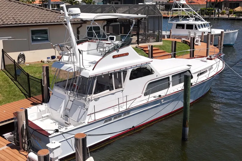 Slide: The Image of Huckins Atlantic 44 yacht, 2006 model, docked at a marina with waterfront homes. - 5