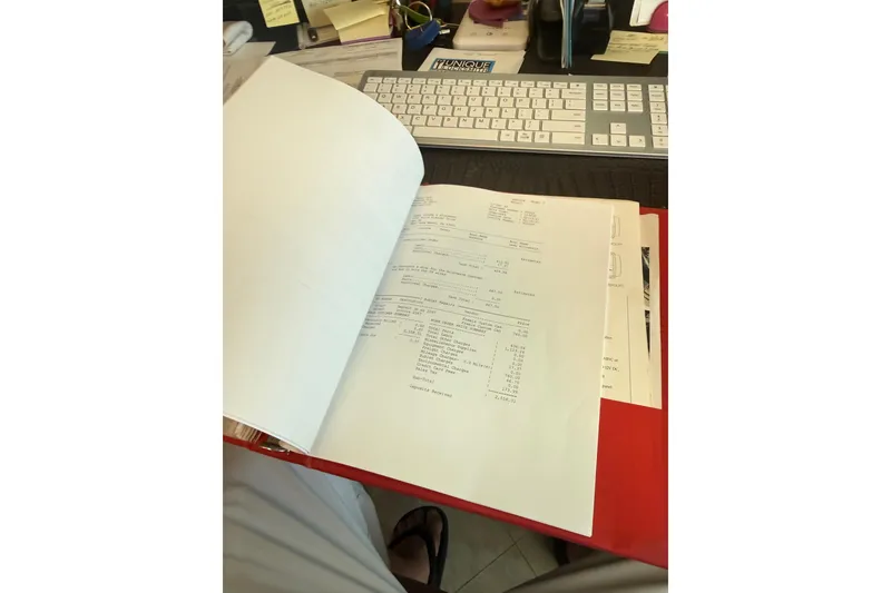 Slide: The Image of Office desk with documents, keyboard, and Huckins Atlantic 44 paperwork, 2006 model. - 52