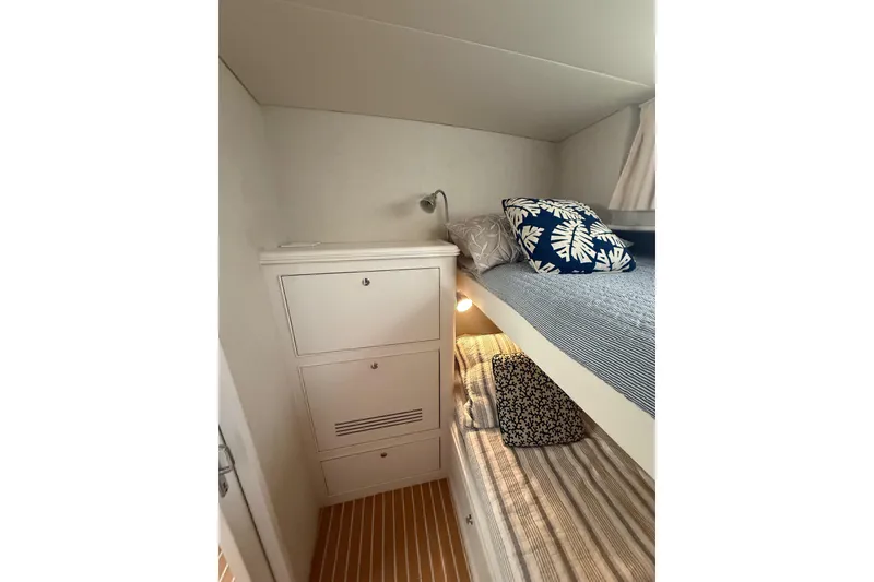 Slide: The Image of Cozy cabin interior of 2006 Huckins Atlantic 44 with bunk beds and nautical decor. - 61