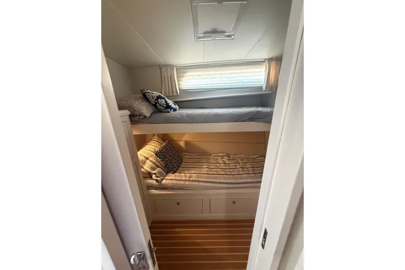 Slide: The Image of Cozy bunk beds in 2006 Huckins Atlantic 44 yacht cabin with natural light. - 62