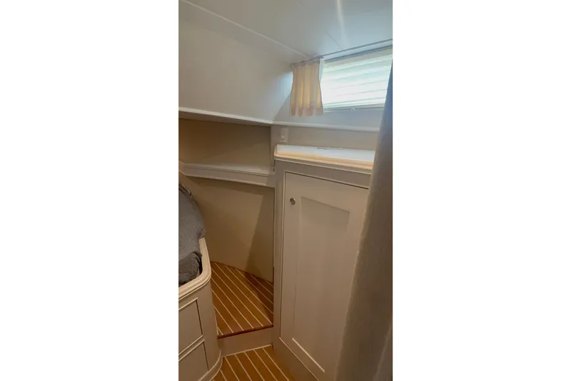 Slide: The Image of Interior cabin of 2006 Huckins Atlantic 44 yacht with wooden flooring and storage. - 65
