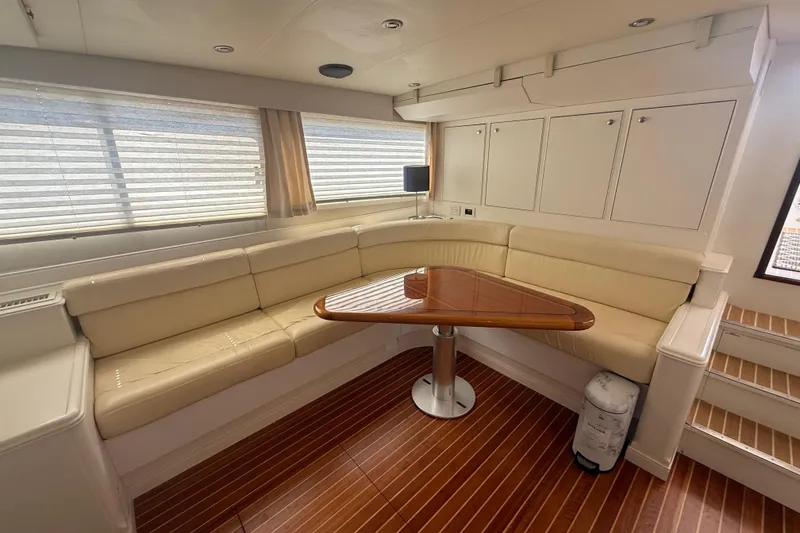 Slide: The Image of Luxurious interior of a 2006 Huckins Atlantic 44 yacht with elegant seating and wooden table. - 66