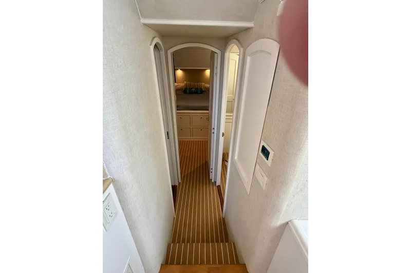 Slide: The Image of Interior hallway of 2006 Huckins Atlantic 44 yacht, featuring elegant wood flooring and cozy cabin entrance. - 67