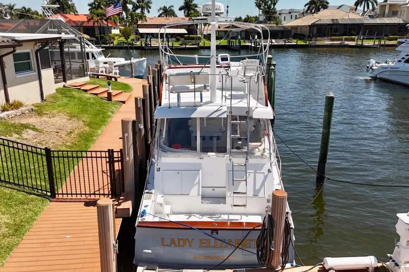 Slide: The Image of Huckins Atlantic 44 yacht docked by waterfront homes, 2006 model, named "Lady Elizabeth." - 7