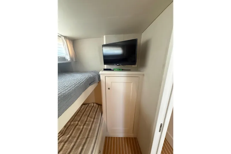Slide: The Image of Interior of 2006 Huckins Atlantic 44 yacht with bunk beds and wall-mounted TV. - 70
