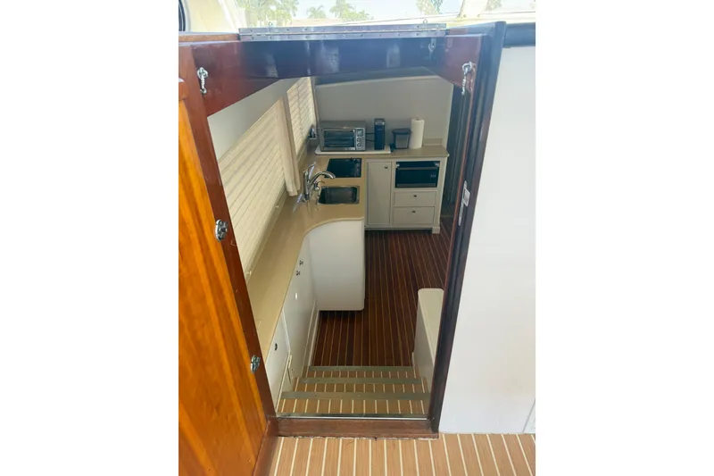 Slide: The Image of Interior view of 2006 Huckins Atlantic 44 yacht kitchen with wooden flooring. - 71
