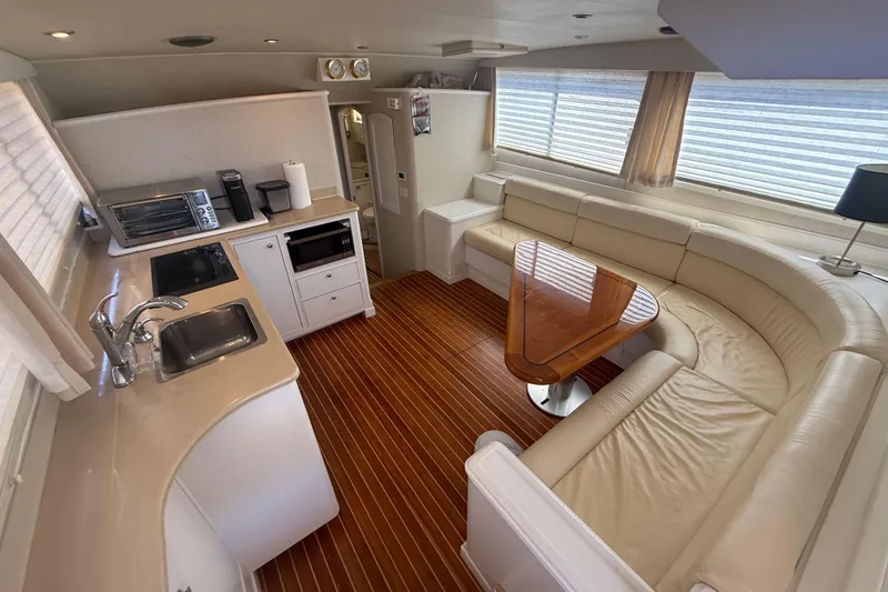 Slide: The Image of Luxurious interior of 2006 Huckins Atlantic 44 yacht with kitchen and curved seating area. - 72