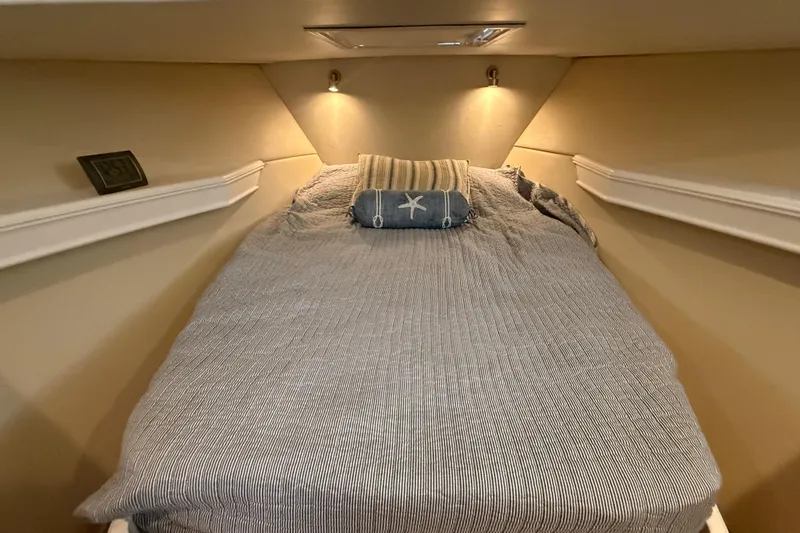 Slide: The Image of Cozy cabin bed in 2006 Huckins Atlantic 44 yacht, featuring soft lighting and nautical decor. - 73
