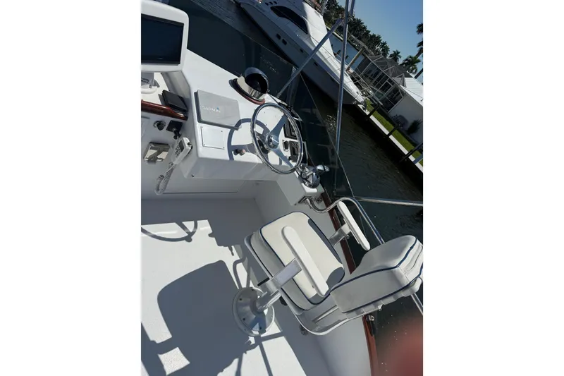 Slide: The Image of Cockpit of 2006 Huckins Atlantic 44 yacht with steering wheel and navigation equipment. - 80