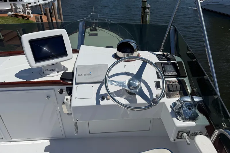 Slide: The Image of Helm of 2006 Huckins Atlantic 44 yacht with Garmin navigation system and steering wheel. - 81