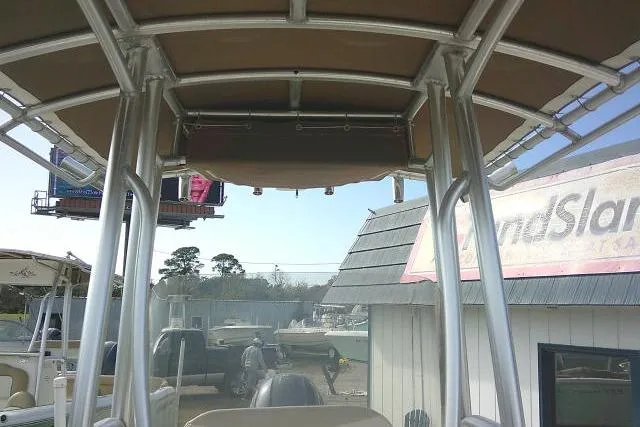 Slide: The Image of 2016 Robalo R200 Center Console boat with T-top in a marina setting. - 22