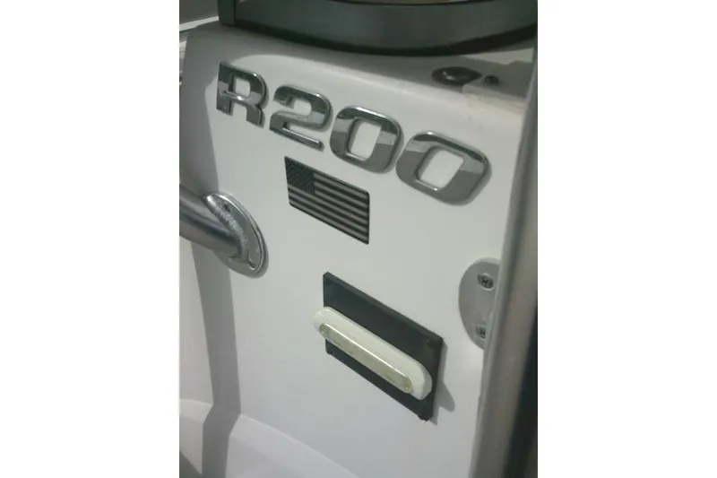 Slide: The Image of 2016 Robalo R200 Center Console boat detail with American flag emblem. - 26