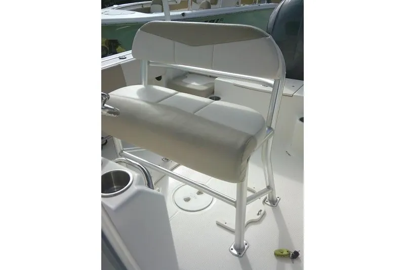 Slide: The Image of 2016 Robalo R200 Center Console boat seat with white cushioned bench and metal frame. - 36