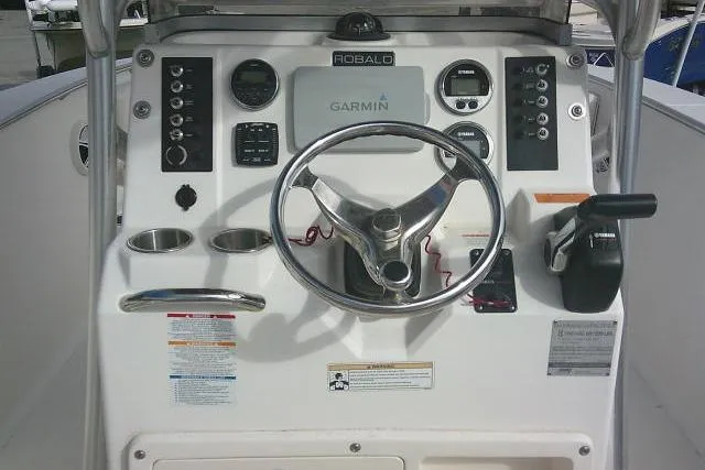 Slide: The Image of 2016 Robalo R200 Center Console dashboard with Garmin navigation system and steering wheel. - 38