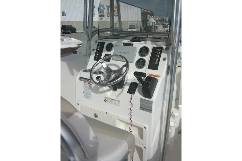 Slide: The Image of 2016 Robalo R200 Center Console boat dashboard with steering wheel and controls. - 45